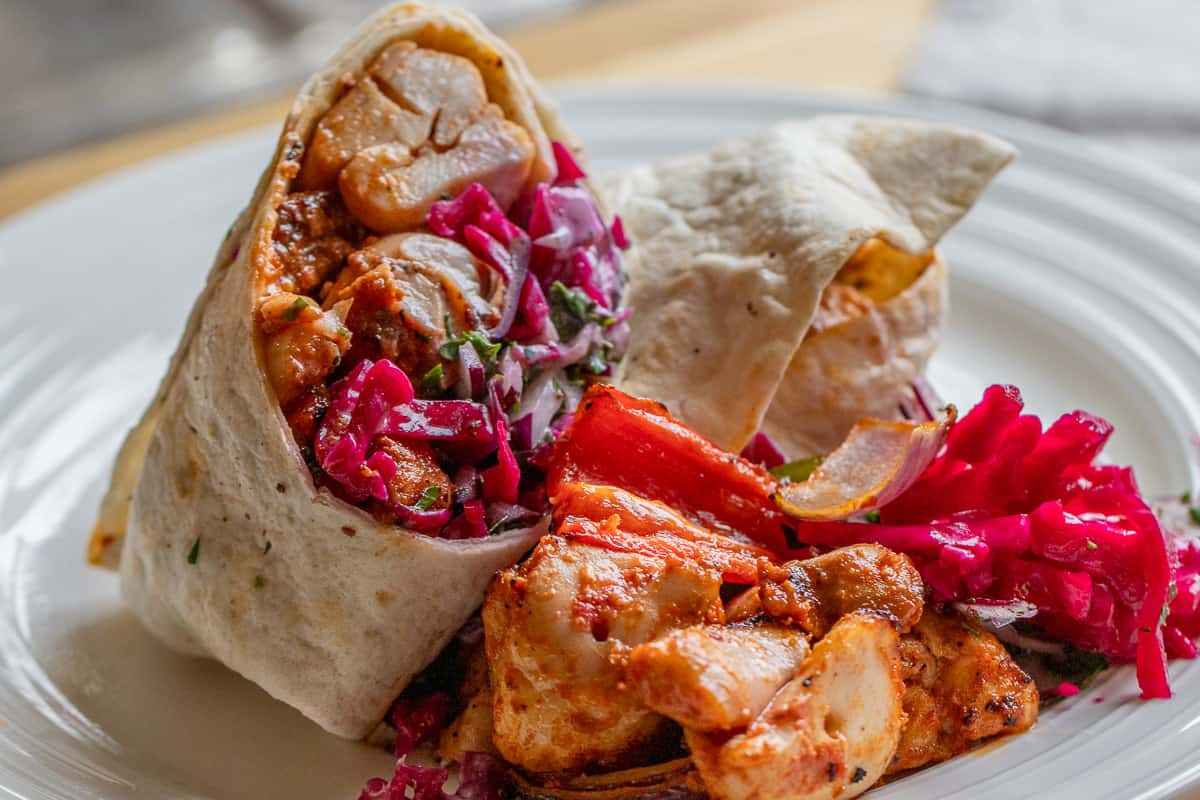 Tavuk Sis wrap served with salad.