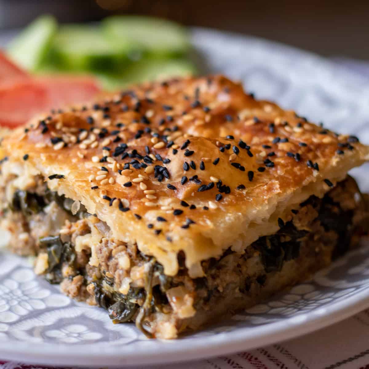 A slice of Egyptian Goulash showing the meat and spinach filling.